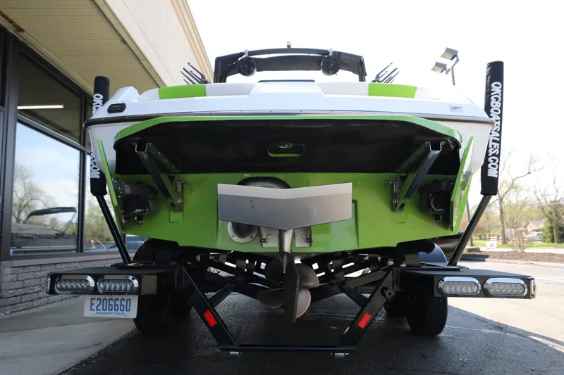 Slide: The Image of 2019 Axis T22 boat rear view with green hull on trailer. - 6