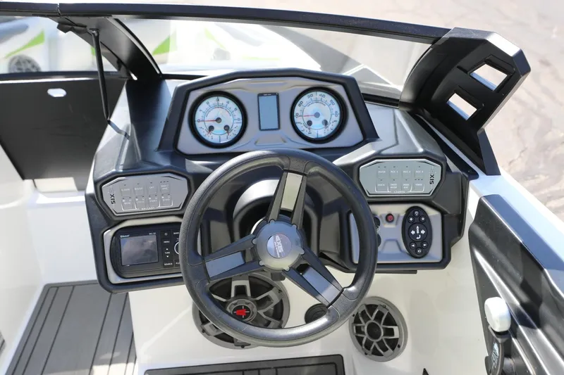 Slide: The Image of 2019 Axis T22 boat dashboard with steering wheel, gauges, and control panels. - 7