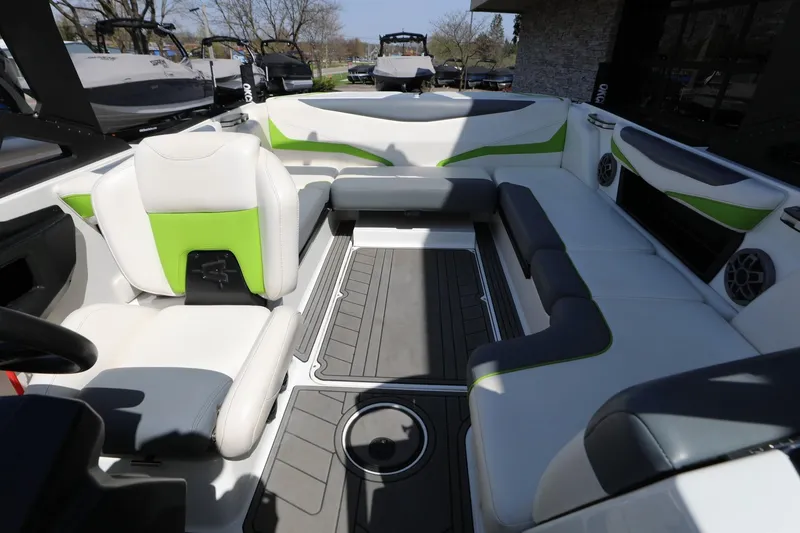 Slide: The Image of 2019 Axis T22 boat interior with white and green seating, spacious layout, and modern design. - 9