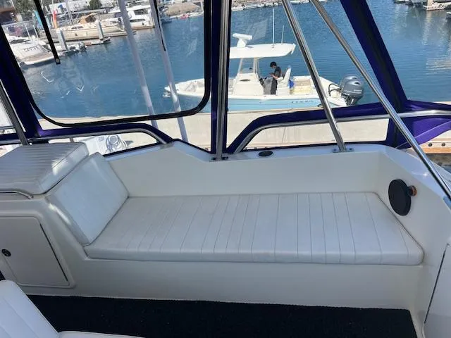 Slide: The Image of Interior seating of 1997 Riviera 43 Open Flybridge yacht with marina view. - 22