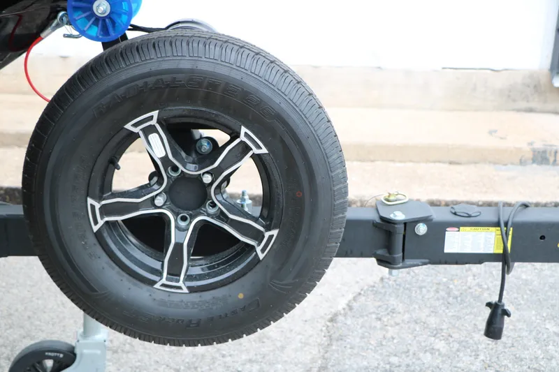Slide: The Image of Spare tire on a 2026 Chaparral 21 SSi boat trailer. - 16