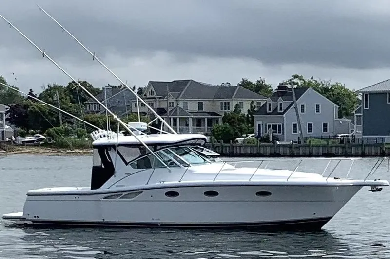The Image of 2004 Tiara Yachts 3500 Open boat on water near residential shoreline. - 0