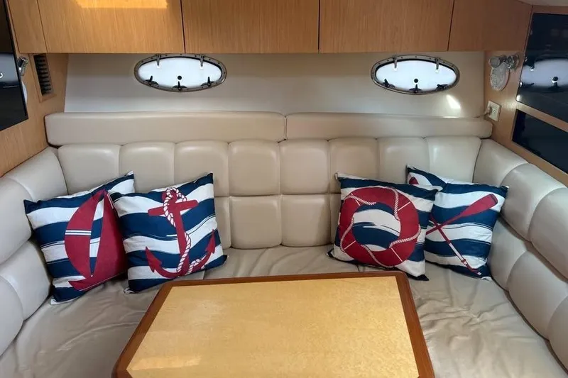 Slide: The Image of Interior of 2004 Tiara Yachts 3500 Open with nautical-themed cushions and cozy seating area. - 10