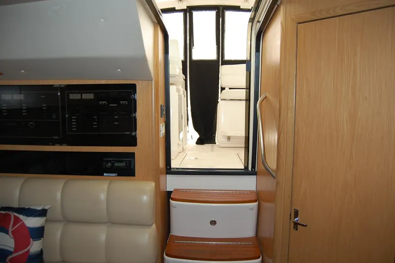 Slide: The Image of Interior view of 2004 Tiara Yachts 3500 Open, featuring cabin steps and control panels. - 14