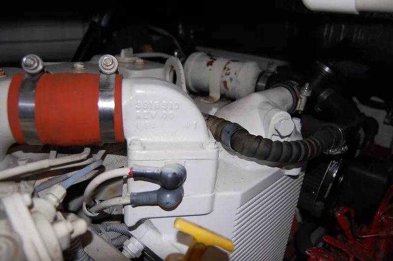Slide: The Image of Engine compartment of a 2004 Tiara Yachts 3500 Open, featuring hoses and components. - 21