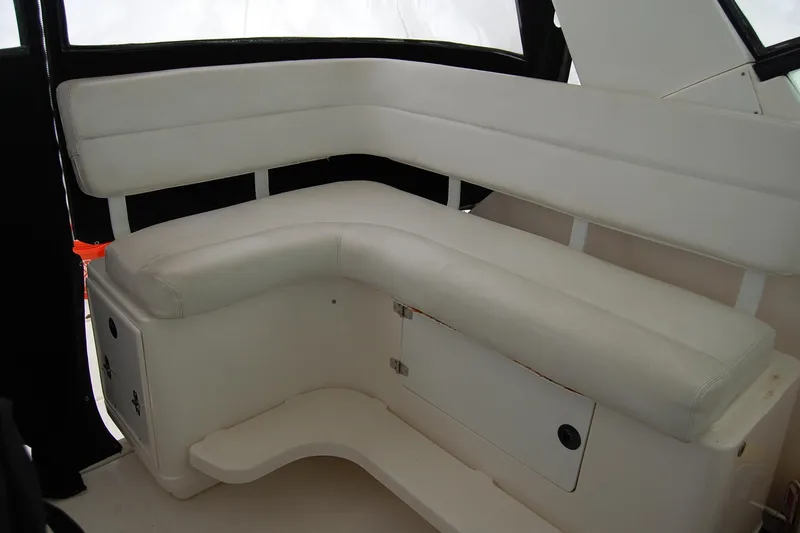 Slide: The Image of 2004 Tiara Yachts 3500 Open interior seating with white upholstery. - 4
