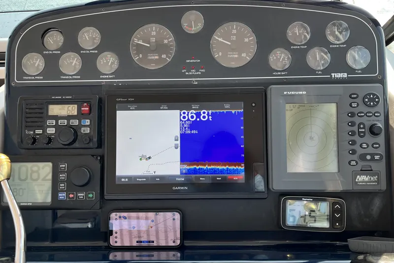 Slide: The Image of Dashboard of a 2004 Tiara Yachts 3500 Open with navigation and control instruments. - 6