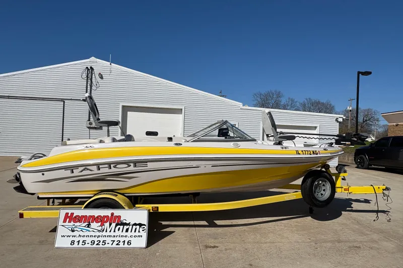 The Image of 2005 Tahoe Q4 SF boat on yellow trailer at Hennepin Marine dealership. - 0