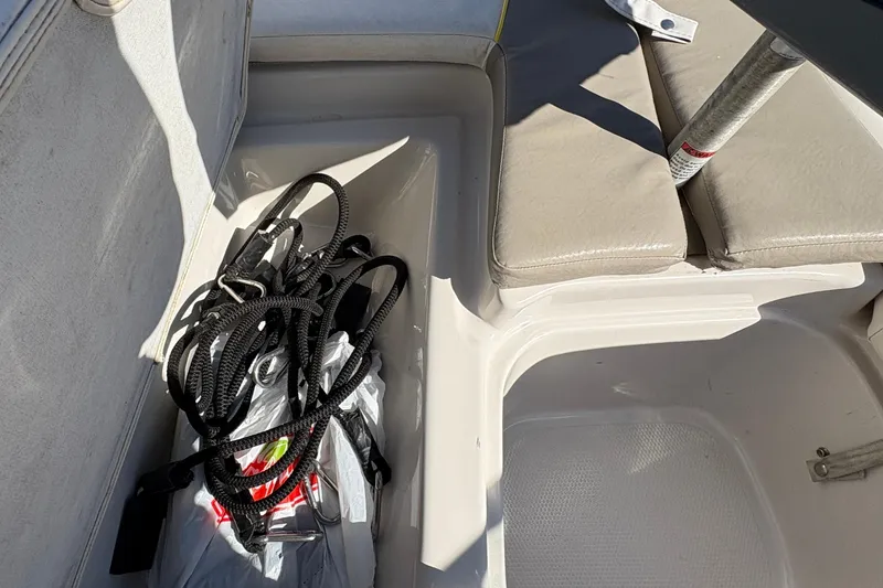 Slide: The Image of 2005 Tahoe Q4 SF boat interior with storage compartment and coiled ropes. - 12