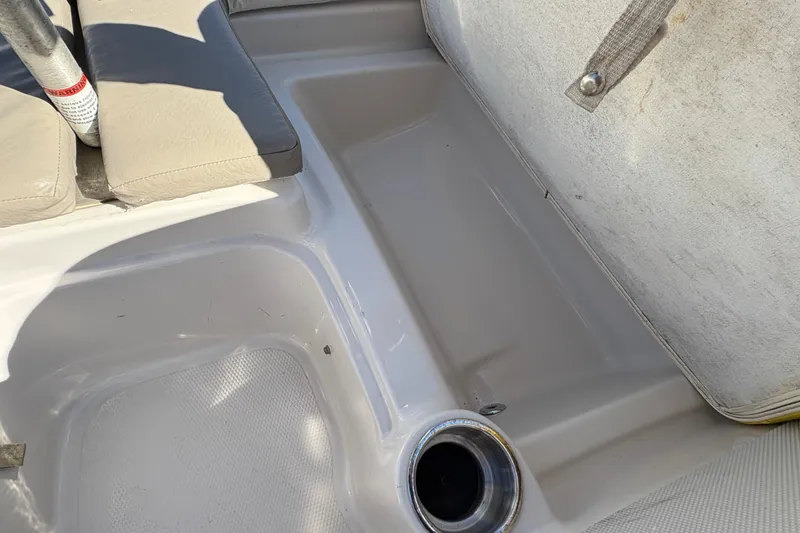 Slide: The Image of Interior of a 2005 Tahoe Q4 SF boat, featuring seating and cup holder. - 13