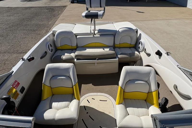 Slide: The Image of 2005 Tahoe Q4 SF boat interior with white and yellow seating, showcasing spacious design. - 14