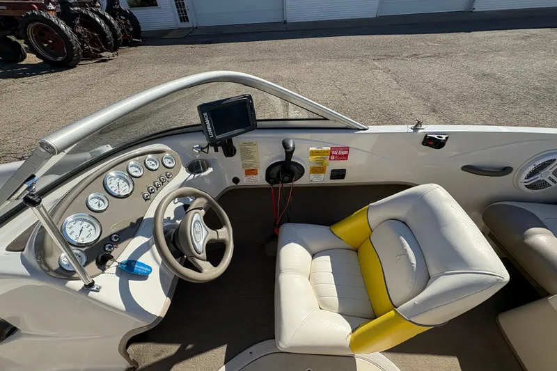 Slide: The Image of 2005 Tahoe Q4 SF boat cockpit with steering wheel, gauges, and yellow-accented seat. - 15