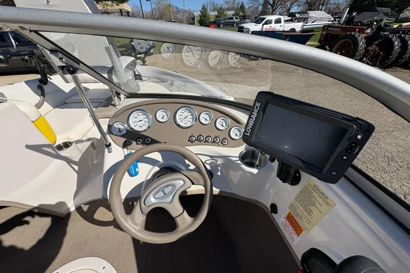 Slide: The Image of 2005 Tahoe Q4 SF boat dashboard with steering wheel and navigation system. - 16