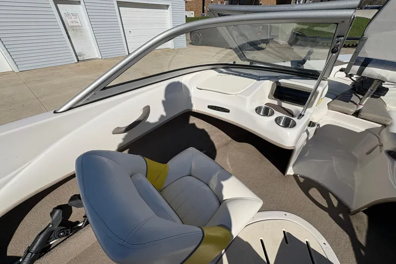 Slide: The Image of Interior of a 2005 Tahoe Q4 SF boat with seating and dashboard view. - 17