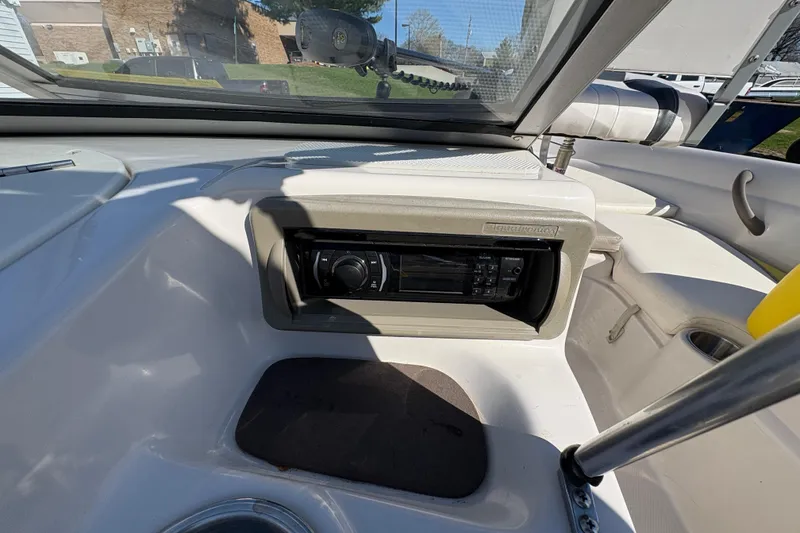 Slide: The Image of 2005 Tahoe Q4 SF boat interior with stereo system and seating area. - 19