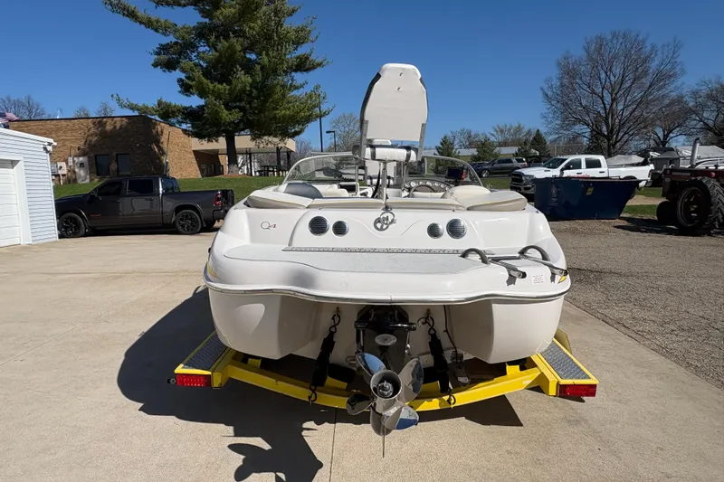 Slide: The Image of 2005 Tahoe Q4 SF boat on trailer, parked outdoors under clear blue sky. - 2