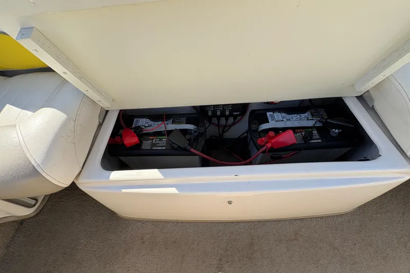 Slide: The Image of 2005 Tahoe Q4 SF boat battery compartment with dual batteries and wiring. - 21