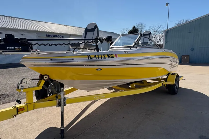 Slide: The Image of Yellow 2005 Tahoe Q4 SF boat on trailer outside showroom. - 5