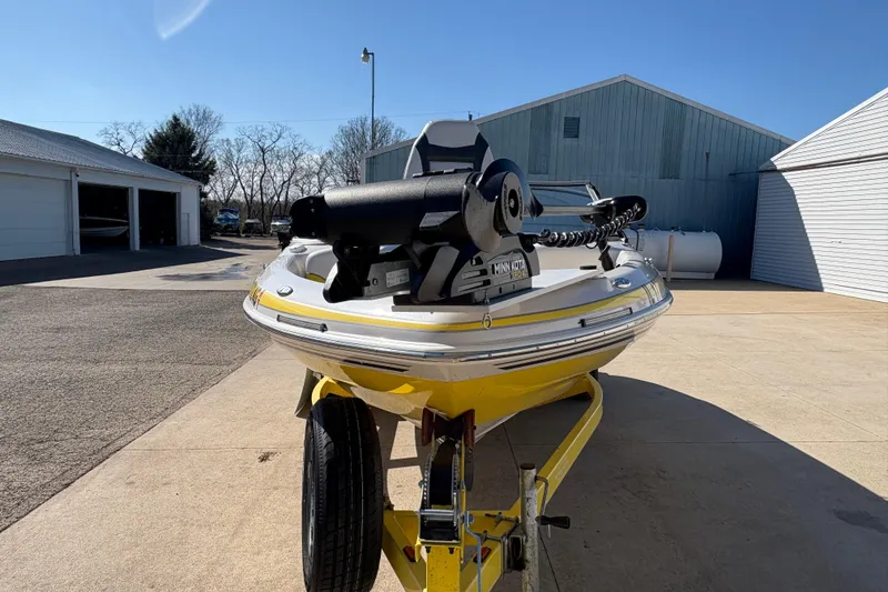 Slide: The Image of 2005 Tahoe Q4 SF boat on trailer, parked outdoors near garages. - 6