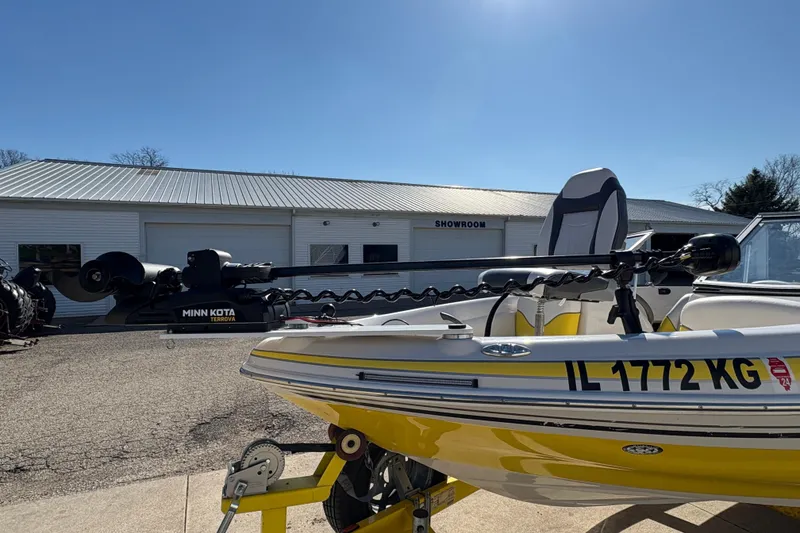 Slide: The Image of 2005 Tahoe Q4 SF boat with Minn Kota motor, parked outside a showroom. - 7
