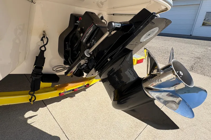 Slide: The Image of 2005 Tahoe Q4 SF boat with MerCruiser outdrive and stainless steel propeller on a yellow trailer. - 9