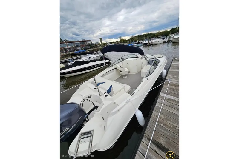 Slide: The Image of 2013 Stingray 234 LR boat docked at marina, featuring sleek design and Yamaha engine. - 4