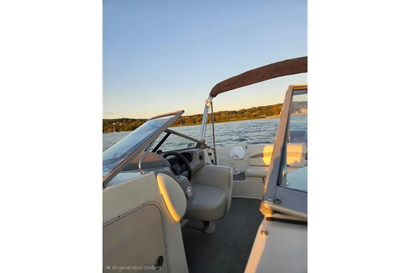 Slide: The Image of 2013 Stingray 234 LR boat interior with lake view at sunset. - 8