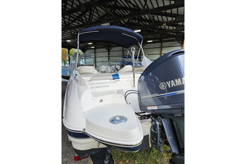 Slide: The Image of 2013 Stingray 234 LR boat with Yamaha outboard motor in covered storage. - 9