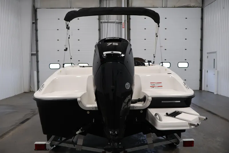 Slide: The Image of 2026 Bayliner Element E16 boat with Mercury 75 engine in a garage setting. - 12