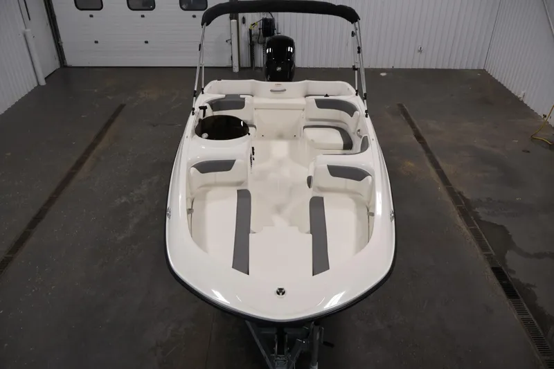 Slide: The Image of 2026 Bayliner Element E16 boat in a garage, showcasing seating and layout. - 15