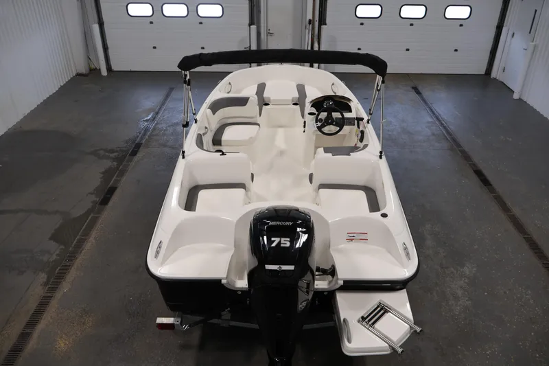 Slide: The Image of 2026 Bayliner Element E16 boat in a garage, featuring a 75 HP Mercury engine. - 16