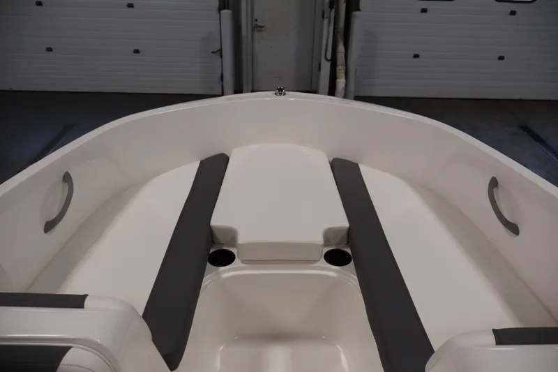 Slide: The Image of 2026 Bayliner Element E16 boat interior with cushioned seating and cup holders. - 17