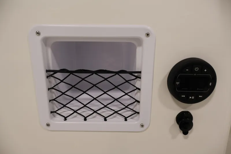 Slide: The Image of 2026 Bayliner Element E16 boat storage compartment and control panel. - 23