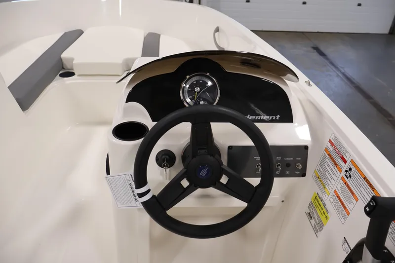 Slide: The Image of 2026 Bayliner Element E16 boat dashboard with steering wheel and control panel. - 25
