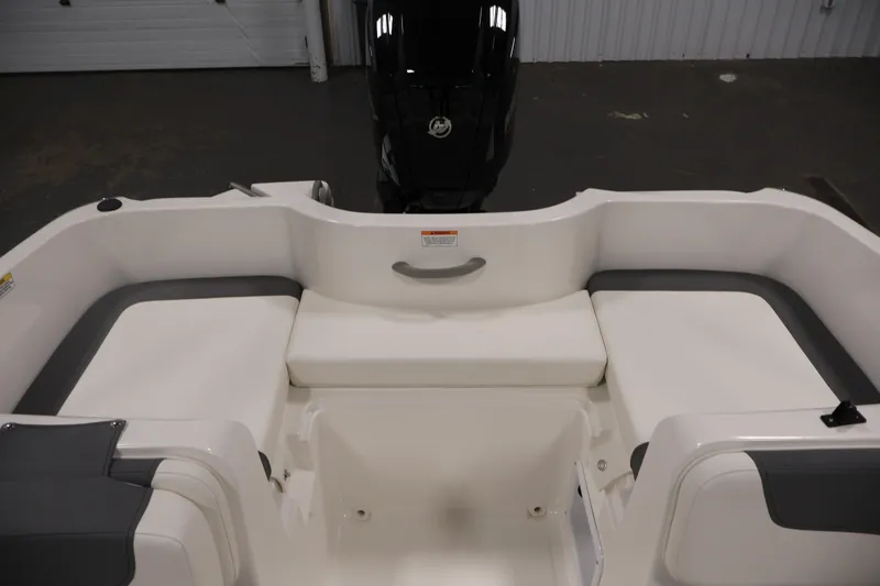 Slide: The Image of 2026 Bayliner Element E16 boat interior with cushioned seating and motor view. - 34