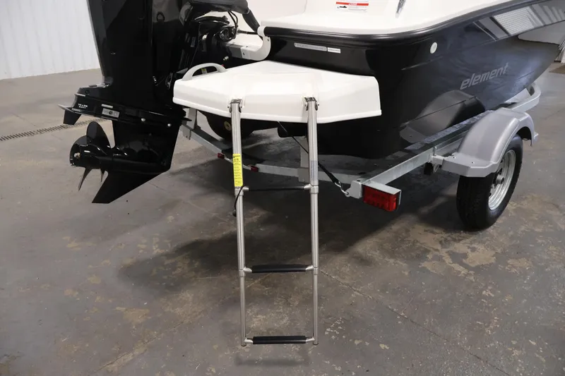 Slide: The Image of 2026 Bayliner Element E16 boat with ladder and trailer, rear view. - 38
