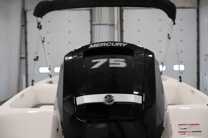 Slide: The Image of 2026 Bayliner Element E16 with Mercury 75 outboard motor in a garage setting. - 41
