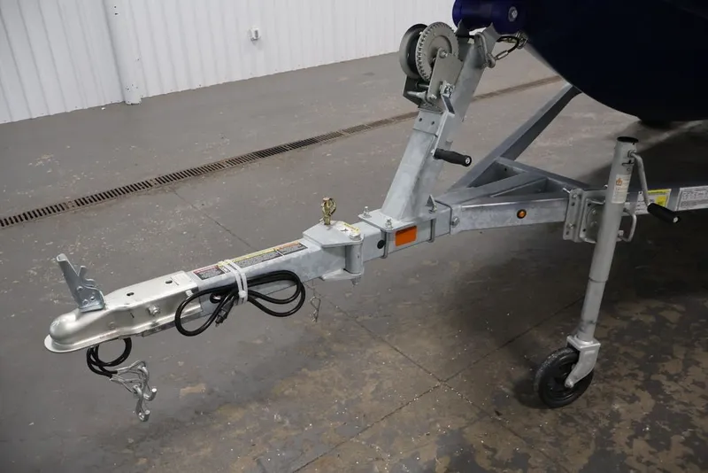 Slide: The Image of Trailer hitch of a 2026 Bayliner Element E16 boat, parked indoors. - 31