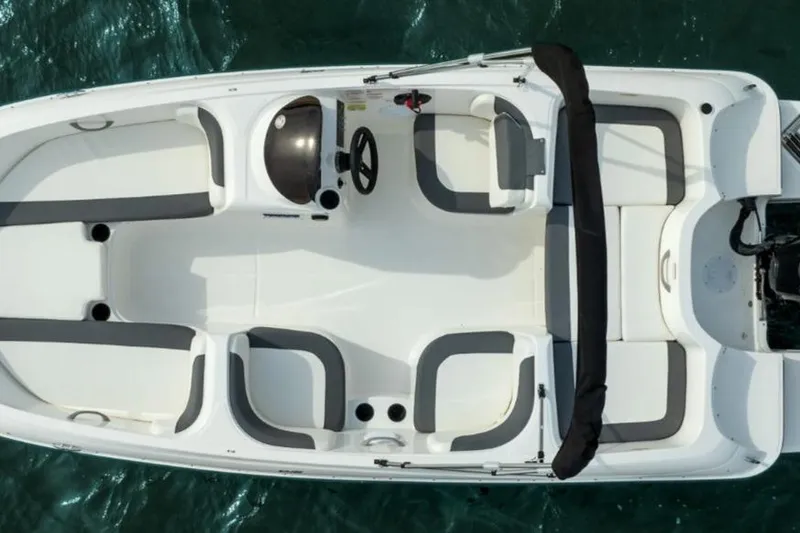 Slide: The Image of 2026 Bayliner Element E16 boat, aerial view, white and gray seating, on water. - 4