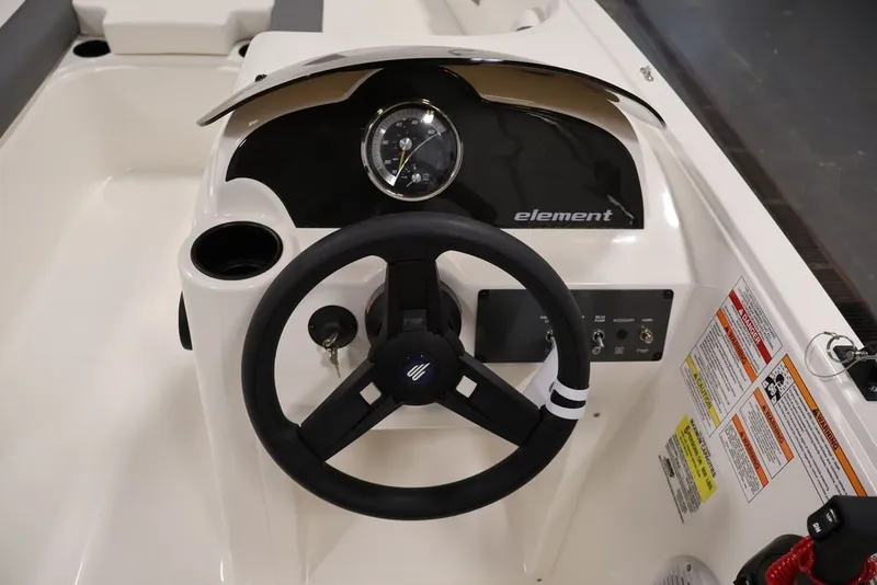 Slide: The Image of Steering console of 2026 Bayliner Element E16 boat with controls and gauges. - 23