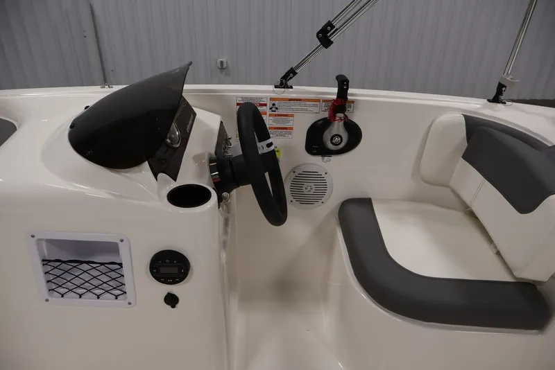 Slide: The Image of 2026 Bayliner Element E16 boat interior with steering wheel and seating area. - 18