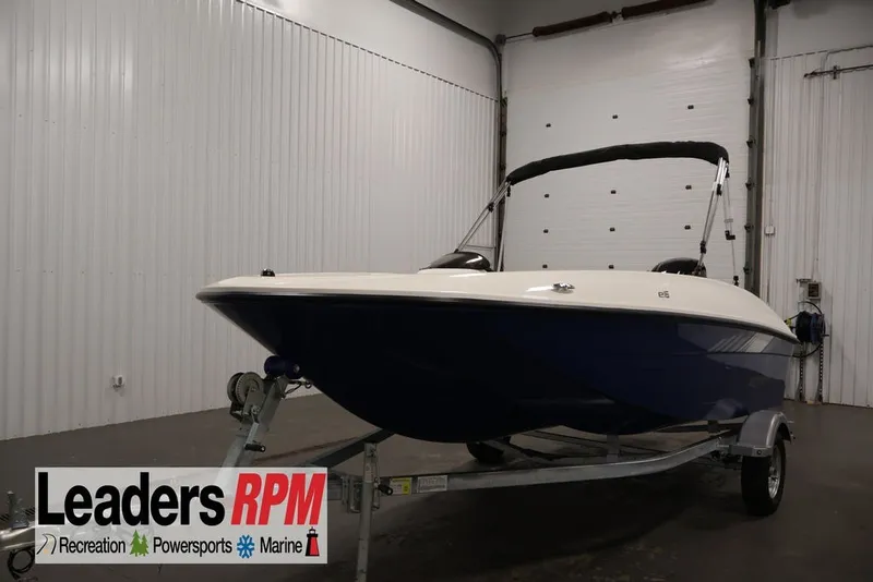 The Image of 2026 Bayliner Element E16 boat on trailer in indoor showroom. - 1