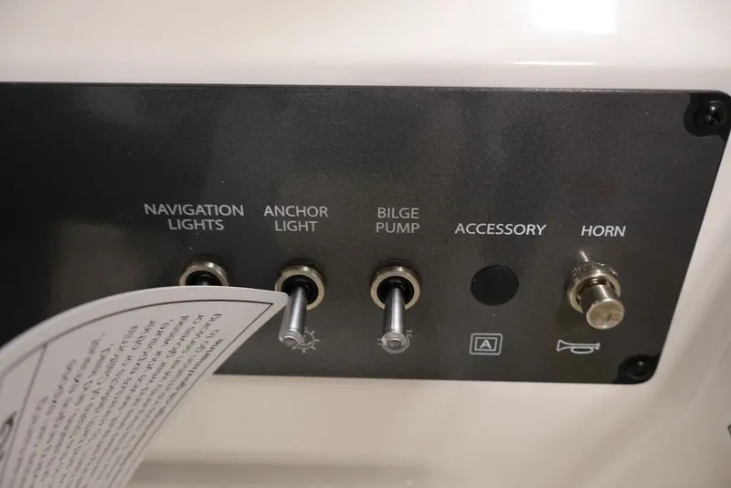 Slide: The Image of Control panel of 2026 Bayliner Element E16 boat with switches for lights and accessories. - 26