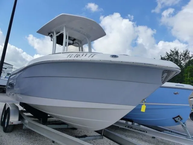 Slide: The Image of 2023 Robalo R222 Explorer boat on trailer, blue sky. - 2
