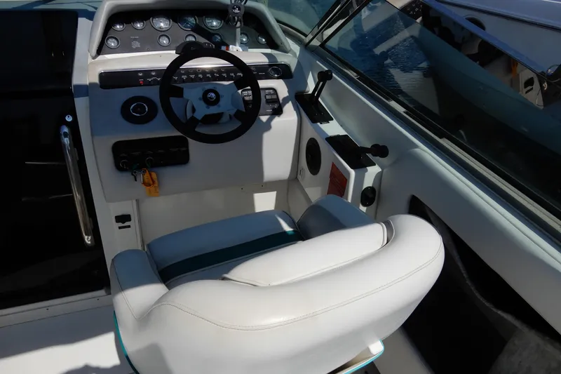 Slide: The Image of Cockpit of 1994 Sea Ray 310 Sun Sport with steering wheel and control panel. - 13