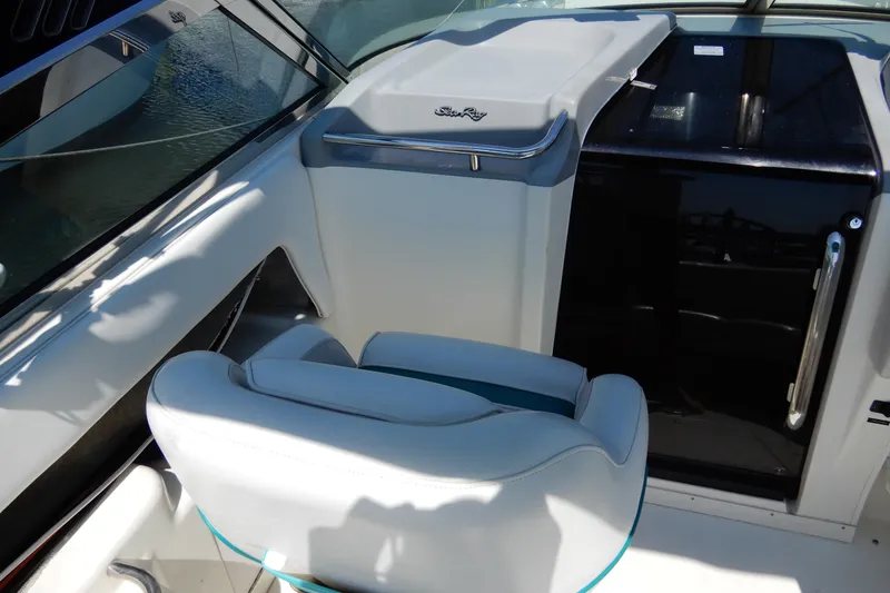 Slide: The Image of 1994 Sea Ray 310 Sun Sport cockpit with white seating and sleek dashboard design. - 14