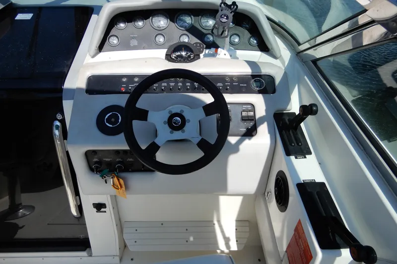 Slide: The Image of Cockpit of a 1994 Sea Ray 310 Sun Sport boat with steering wheel and controls. - 15