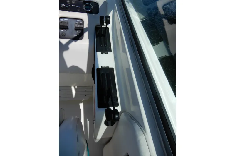 Slide: The Image of 1994 Sea Ray 310 Sun Sport throttle and control panel close-up. - 16