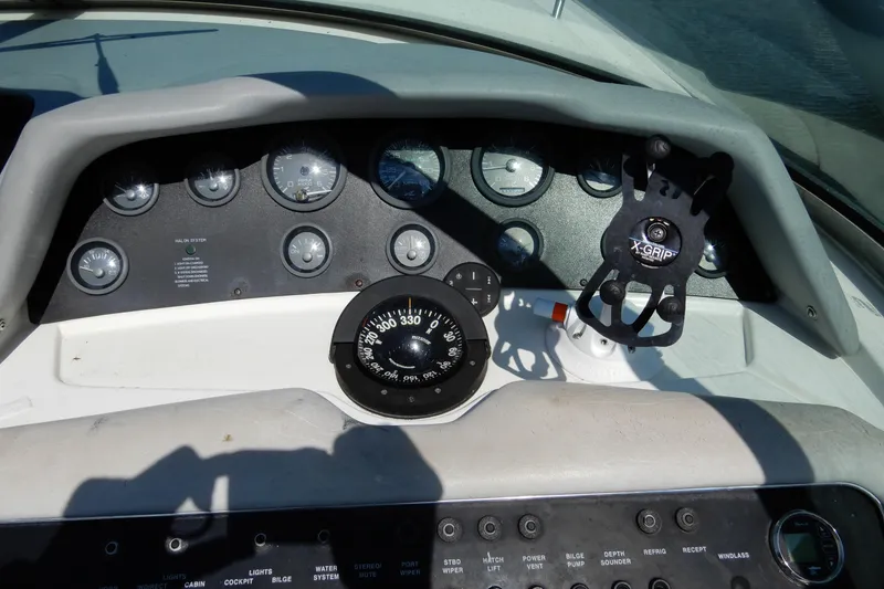 Slide: The Image of Dashboard of a 1994 Sea Ray 310 Sun Sport boat with gauges and controls. - 18
