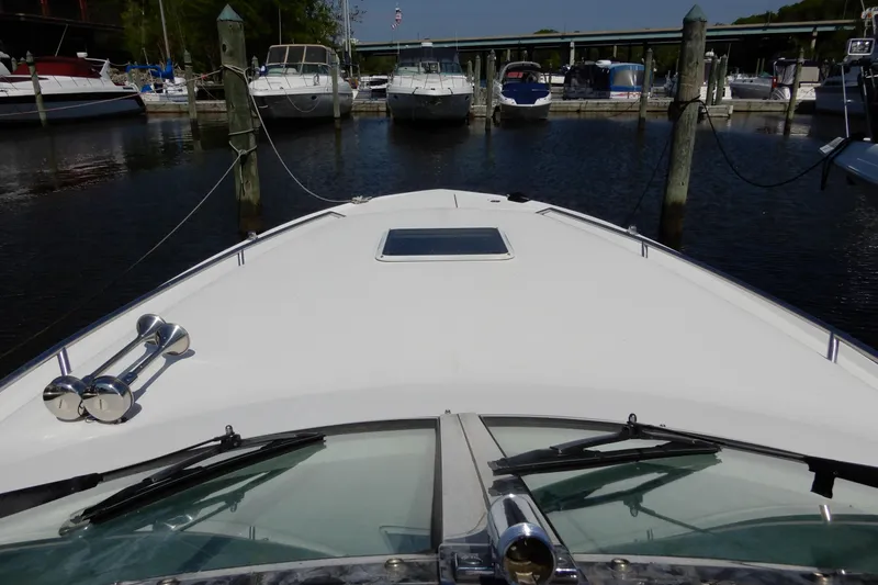 Slide: The Image of 1994 Sea Ray 310 Sun Sport docked at marina, view from bow. - 19